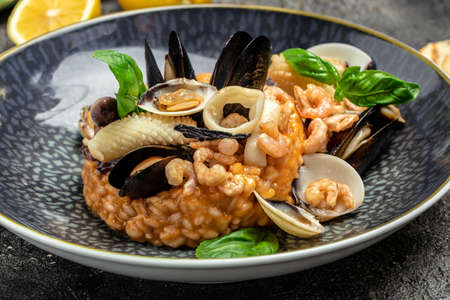 Risotto with seafood shrimp and mussels in shells. Mediterranean cuisine. Restaurant menu, dieting, cookbook recipe top view.の写真素材