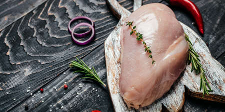 Raw turkey fillet on cutting board, Cooking ingredients. natural healthy food concept. Long banner format. top view,の写真素材