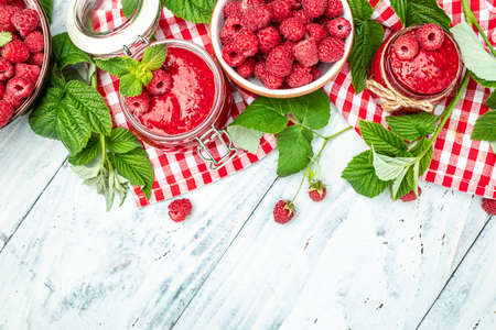 raspberry jam on a white wooden background. Raspberries in a bowl. Organic Raspberries. redberry. banner, menu, recipe place for text, top view.の写真素材