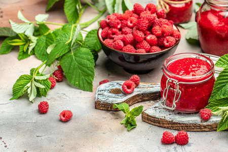 Raspberry jam with berry on light background. Homemade jam with raspberry. banner, menu, recipe place for text, top view.の写真素材