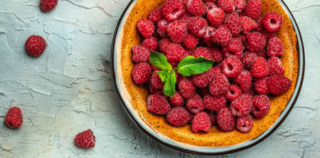 Fresh raspberries in a bowl. Ripe juicy fresh raspberries. Organic raspberries, healthy food, vitamins, summer berry fruit. Long banner format. place for text.の写真素材