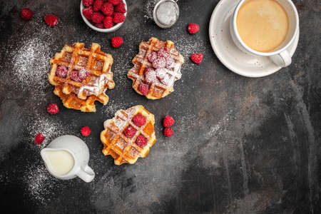 Belgian waffles with raspberries with sugar powder. Traditional Belgian waffles with fresh fruit. banner, menu, recipe place for text, top view. Delicious breakfast or snack.の写真素材