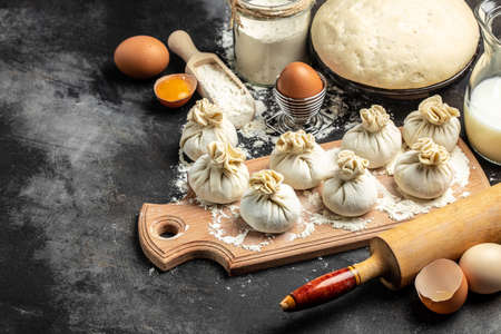 cooking Khinkali with cheese and spinach. Raw semi-finished product dumplings. National Georgian cuisine. place for text, top view.の写真素材