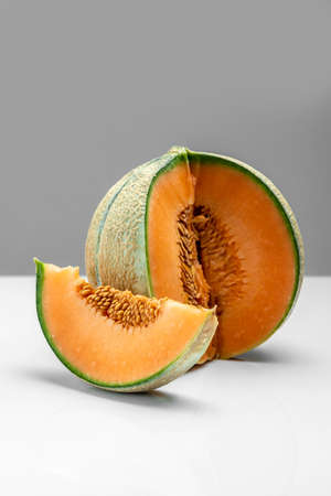 sliced cantaloupe melon. Raw Organic Tuscan Melon Cantaloupe on light background, vertical image. top view.の写真素材