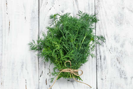Fresh dill close up on wooden box on light background, preparation for freezing serving size organic...