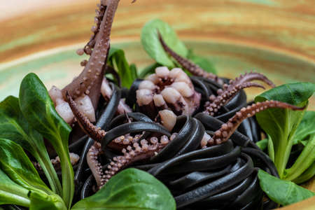 Squid ink spaghetti with seafood octopus, mussels and shrimps on dark background. Restaurant menu, dieting, cookbook Food recipe background. close up top view,の写真素材