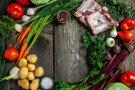 Ingredients for preparing borscht, vegetables for cooking borsch beetroot, cabbage, carrots, potatoes, tomatoes. Ukrainian food red soup borsch, place for text, top view,の写真素材