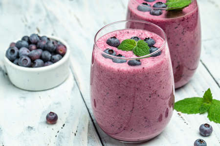 blueberry smoothie in glass on a light background. fruit dessert, healthy dieting concept Natural detox.の写真素材