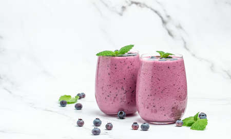 mixed berries with yogurt smoothies fresh blueberries Yogurt cocktail on a light background. natural detox. Long banner format.の写真素材