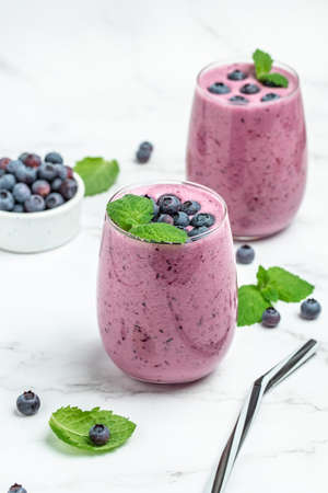 Bilberry yogurt cocktail on a light background. natural detox. vertical image. top view. place for text.の写真素材