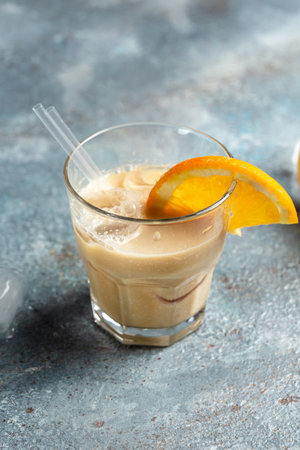 Iced coffee. Cold refreshment summer coffee drink in glasses on concrete stone background. vertical...