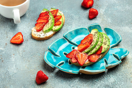 Healthy breakfast sandwiches with avocado strawberries, soft cheese, chia seeds, gluten free diet, place for text.の写真素材
