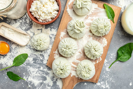 cooking Khinkali with cheese and spinach. Raw semi-finished product dumplings. National Georgian cuisine. place for text, top view.の写真素材