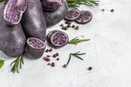 Raw cut purple sweet potatoes isolated on white background.の写真素材