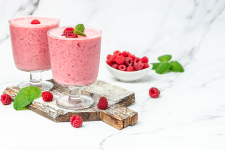 Yogurt smoothie with raspberries in glass on white marble table. natural detox. Long banner format.の写真素材