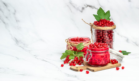 red currant jam with fresh berries. Canned berries on a light background. Long banner format.の写真素材