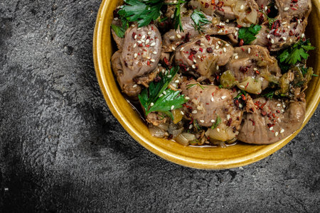 Stewed chicken stomach in bowl. Traditional Korean spicy chicken meat on a dark background. top view.の写真素材