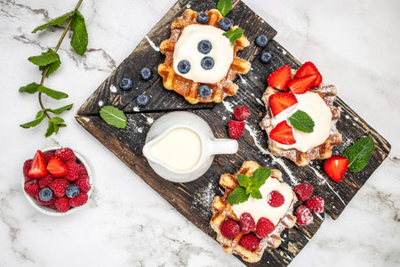 Berry Belgian Waffle with raspberries, strawberries and blueberries. Culinary, cooking, bakery concept. Food recipe background.の写真素材