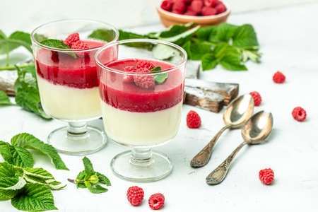 Raspberry sorbet with whipped cream and mint. Italian dessert on a light background in small jars. Long banner format. place for text.の写真素材