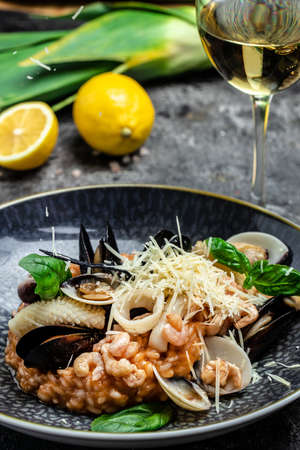 Italian risotto with shrimps, mussels, octopus, clams. Mediterranean cuisine. Restaurant menu, dieting cookbook recipe top view.の写真素材