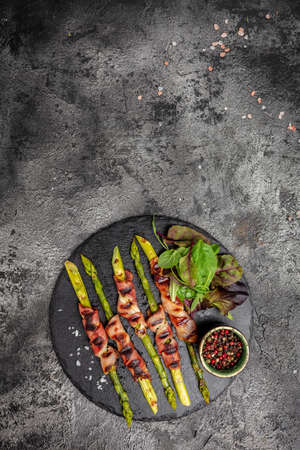 Grilled green asparagus wrapped with bacon. The ketogenic diet. Healthy food, diet menu. vertical image. top view. place for text,の写真素材