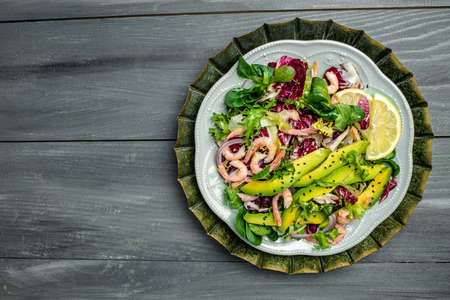 Seafood salad with shrimps, avocado slices and fresh greens, Healthy food. superfood concept. clean eating concept. Vegan or gluten free diet. top view.の写真素材