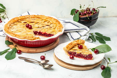 Delicious Homemade Cherry Pie, Flaky Crust, piece on a plate and the whole homemade cherry pie, top view,の写真素材