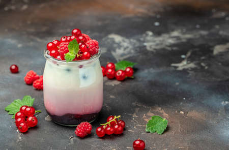 berries Yogurt. Healthy layered dessert with yogurt, jam, red currant and raspberries. natural detox. banner, menu, recipe place for text, top view.の写真素材