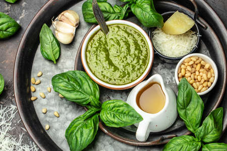 Green basil pesto with italian recipe ingredients, Basil, olive oil, parmesan, garlic, pine nuts. banner, menu, recipe place for text, top view,の写真素材
