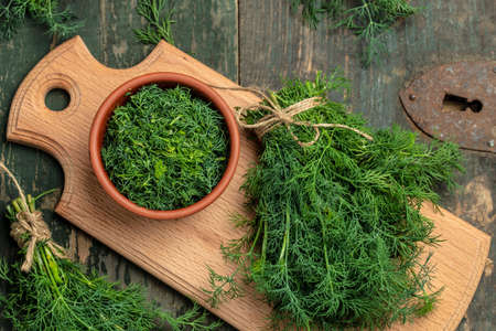 Fresh dill close up on wooden box on dark background, preparation for freezing serving size organic healthy ething natural product portion. place for text.の写真素材
