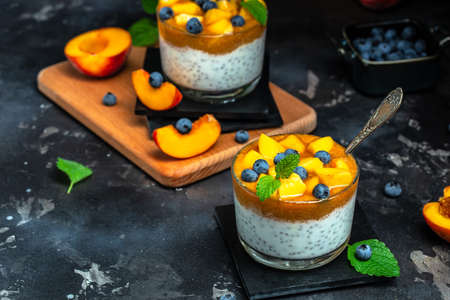 peaches blueberry chia yogurt. Homemade dessert with fruits. place for text, top view.の写真素材