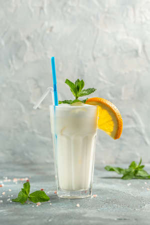 milk shake, milk drink in a glass decorated with orange and fresh mint,の写真素材