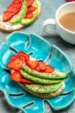 Crostini or toasts with strawberries and cream cheese ricotta. Delicious breakfast or snack, Clean eating, dieting, vegan food concept. top view.の写真素材