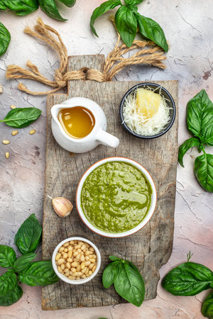 bowl with green pesto pine nuts, parmesan and garlic. vertical image. top view. place for text.の写真素材