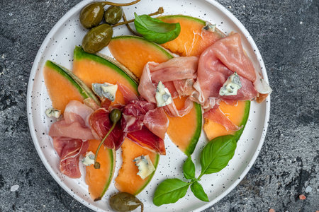 appetizer with sweet melon and ham, dorblu stilton dairy product, blue cheese roquefort gorgonzola, roquefort, cambozola, Food recipe background,の写真素材