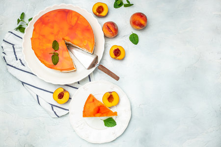 dessert peaches, cheesecake with peache jelly on white plate. Restaurant menu, dieting, cookbook recipe top view.の写真素材