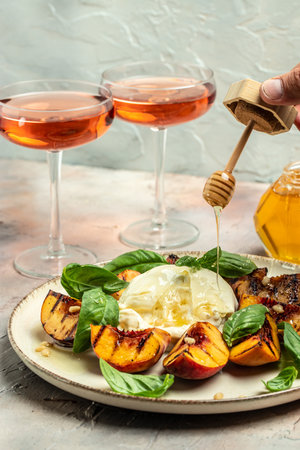 Burrata cheese and grilled peaches with rose wine, vertical image. top view. place for text,の写真素材