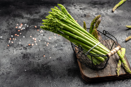 bunch of fresh asparagus on dark background, Pickled Green Asparagus. place for text, top view.の写真素材