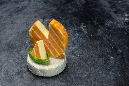 Brie cheese with a white and blue mold, camembert cheese. truffled brie cheese on a dark background, top view,の写真素材