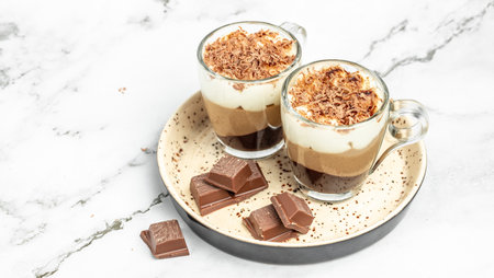 dessert three chocolates pudding decorated with mint on a light background. Layered delicious...