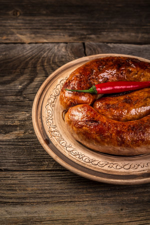 baked meat sausages on a wooden board. banner menu recipe place for text,の写真素材