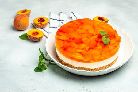 cheesecake with peaches, peache jelly, jam on a light background. banner, menu, recipe place for text, top view.の写真素材