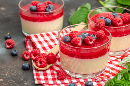 Raspberry sorbet with whipped cream and mint. Italian dessert on a light background in small jars. Long banner format. place for text.の写真素材