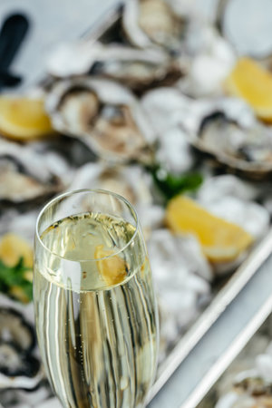 Oysters plate with lemon and champagne in restaurant. Oysters with lemon. vertical image. top view. place for text.の写真素材