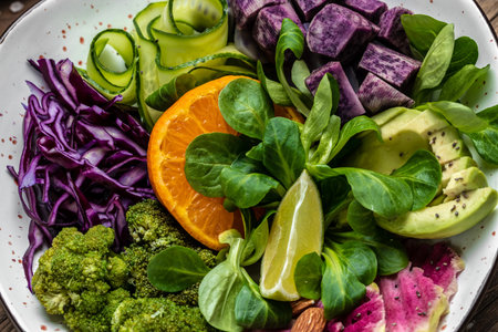 Green salad with sweet potatoes, broccoli, avocado, purple cabbage, cucumber, watermelon radish and almonds. Food recipe background. close up.の写真素材