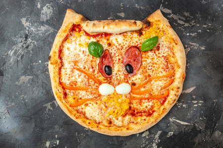 children's pizza in the shape of a cat's face on a dark background, banner, menu, recipe place for text, top view,の写真素材