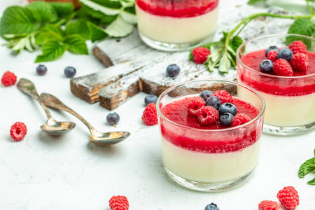 Raspberry sorbet with whipped cream and mint. Italian dessert on a light background in small jars. Long banner format. place for text.の写真素材