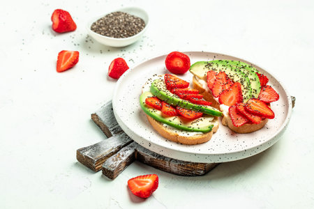 Healthy breakfast sandwiches with avocado strawberries, soft cheese, chia seeds, gluten free diet, place for text, top view,の写真素材