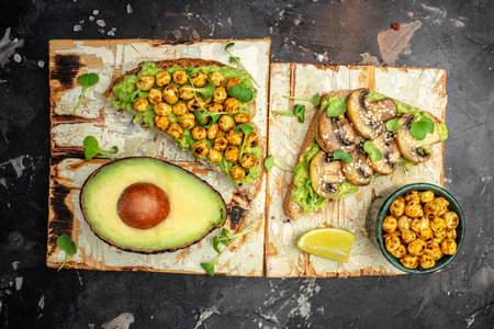 toast with avocado, roasted chickpeas and mushrooms on a dark background. superfood concept. Healthy, clean eating. Vegan or gluten free diet.の写真素材