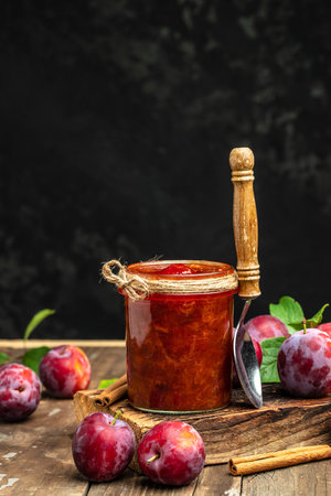 plum jam nd fresh plums on a wooden background. banner, menu, recipe place for text.の写真素材